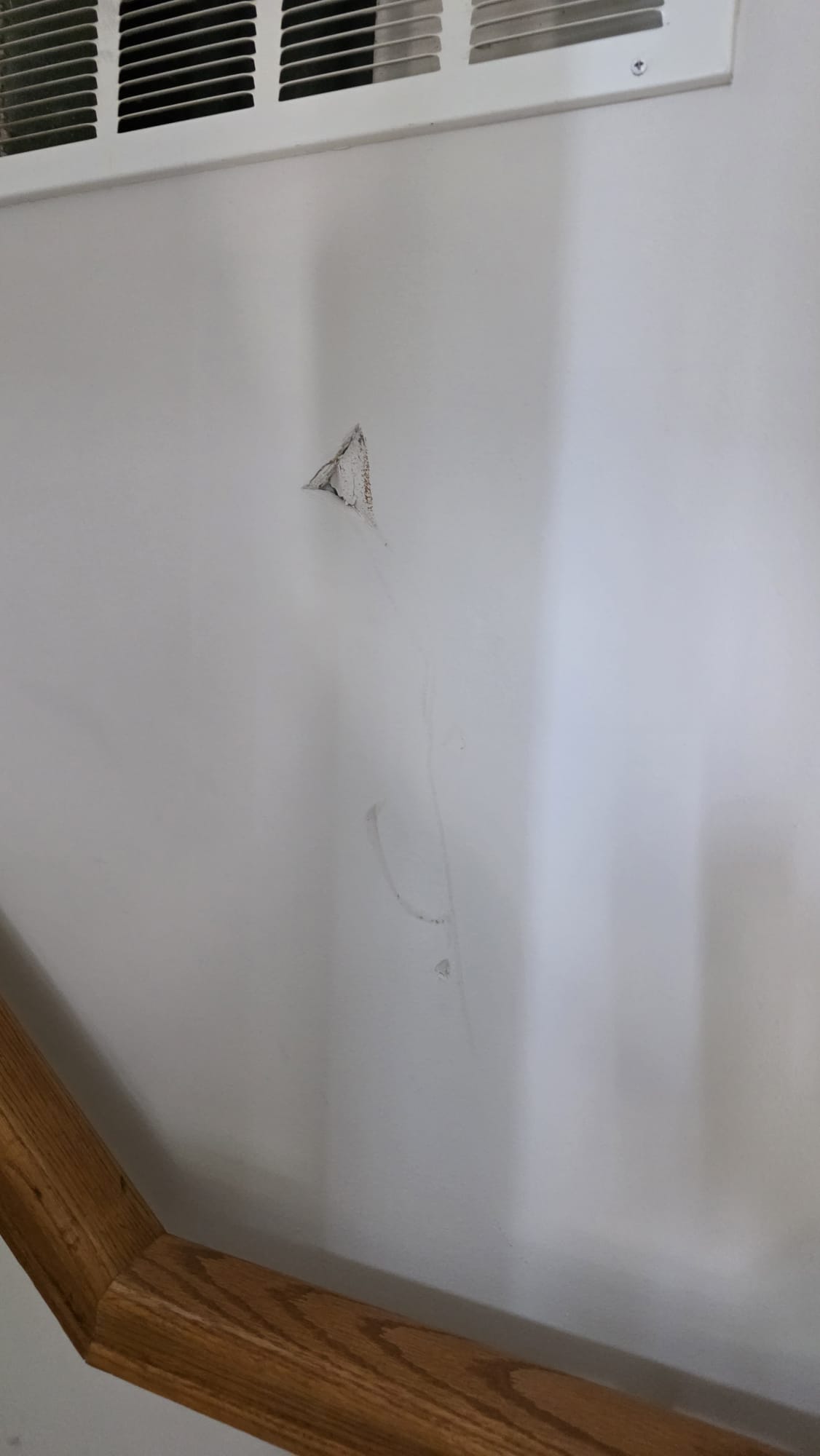Wall damage before repair service by VanGo handyman team in Virginia